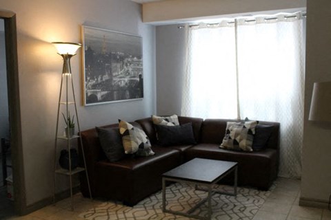 a living room with a couch and a lamp